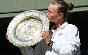 Barbora Krejcikova kisses the Wimbledon trophy after her win in the women's singles.