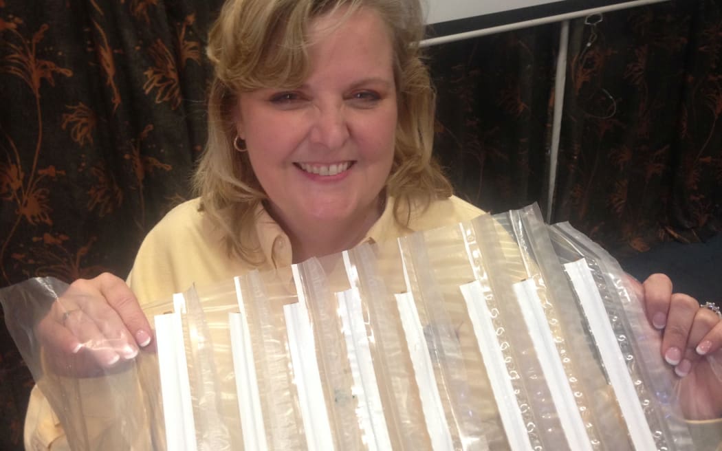 Chief of the NASA Balloon Program, Debbie Fairbrother, holds a piece of the balloon material.