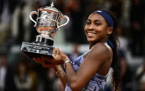Coco Gauff holds the trophy after winning the French Open tennis tournament women's singles final match against Belarus' Aryna Sabalenka.
