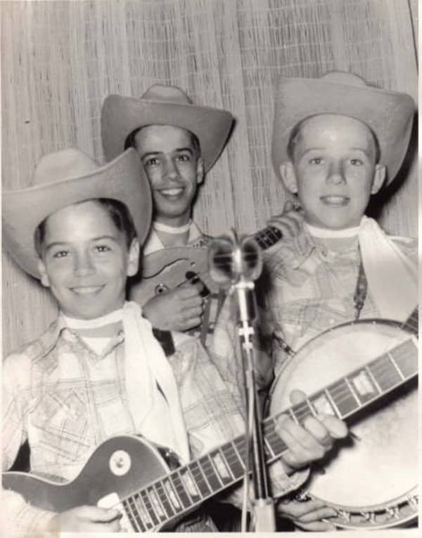 Clarence, Roland and Eric White as children, dressed as cowboys