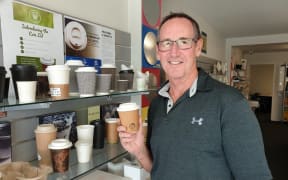 Glopac general manager Chris Thomson with one of the plastic-free coffee cups.