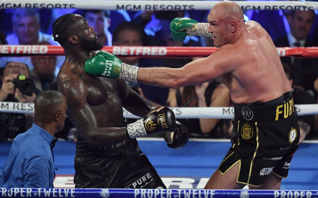 British boxer Tyson Fury (R) lands a punch on US boxer Deontay Wilder during their World Boxing Council (WBC) Heavyweight Championship Title boxing match.