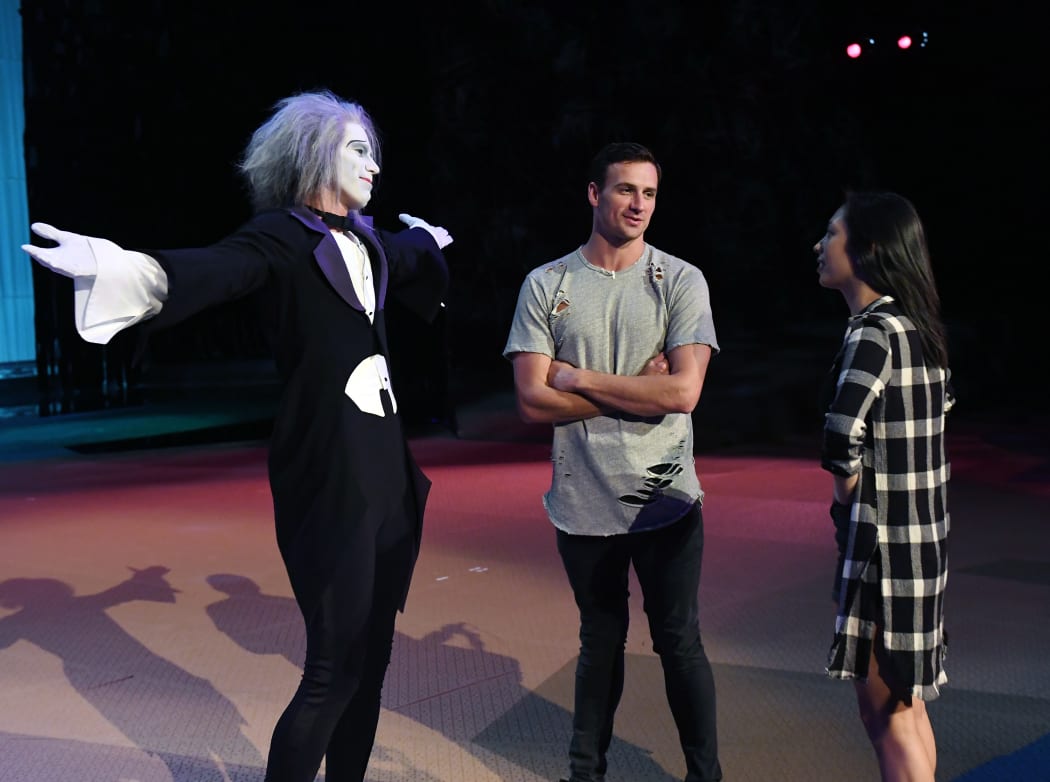 "O by Cirque du Soleil" performer Benedikt Negro as the character Le Vieux talks with Olympian Ryan Lochte and dancer Cheryl Burke as they rehearse for Dancing with the Stars.