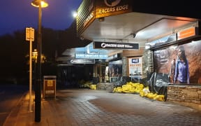 Stores in Wanaka are prepared for flooding with sandbags and plastic sheeting.
