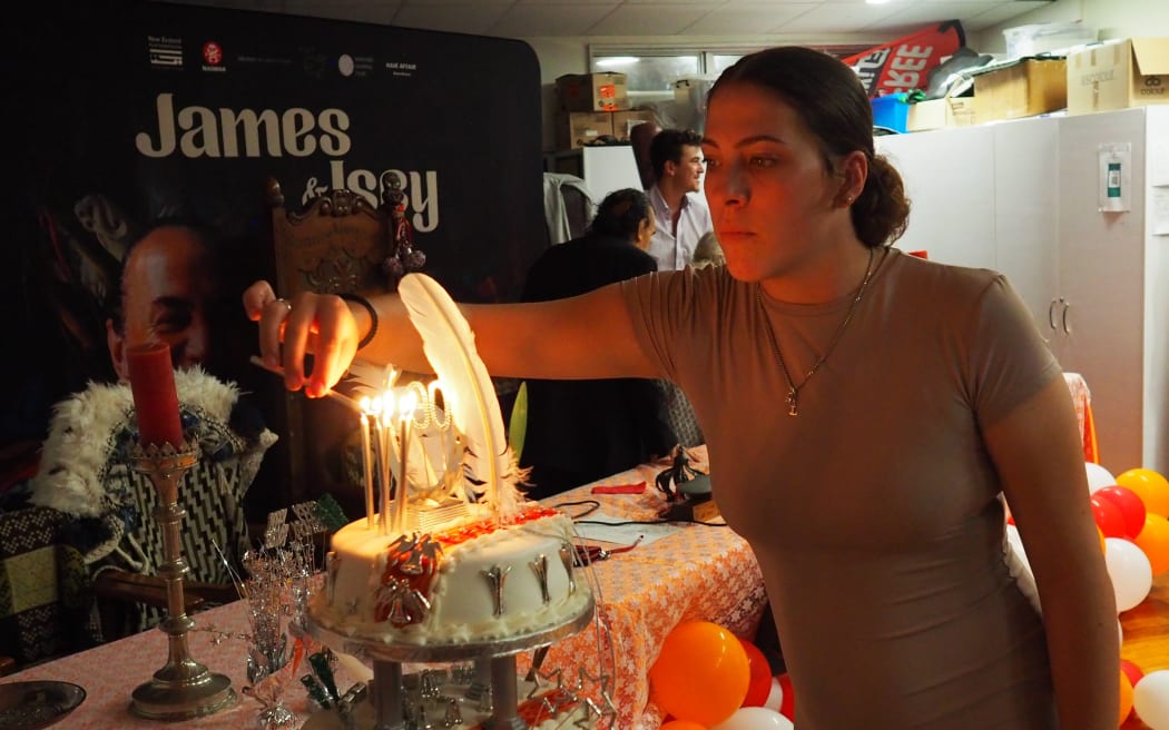 Liana Masefield lights the candles on Isey’s cake.