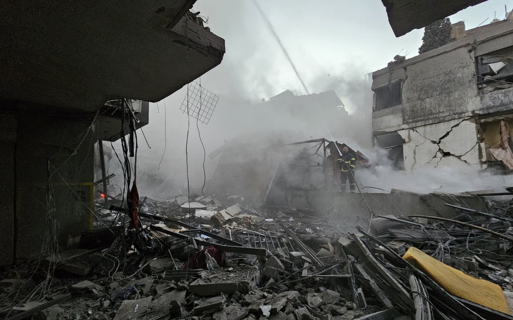 A firefighter battles a blaze at the site of an Israeli airstrike that targeted the Shiyah neighborhood in Beirut’s southern suburbs on November 26, 2024, amid the ongoing war between Israel and Hezbollah. (Photo by AFP)