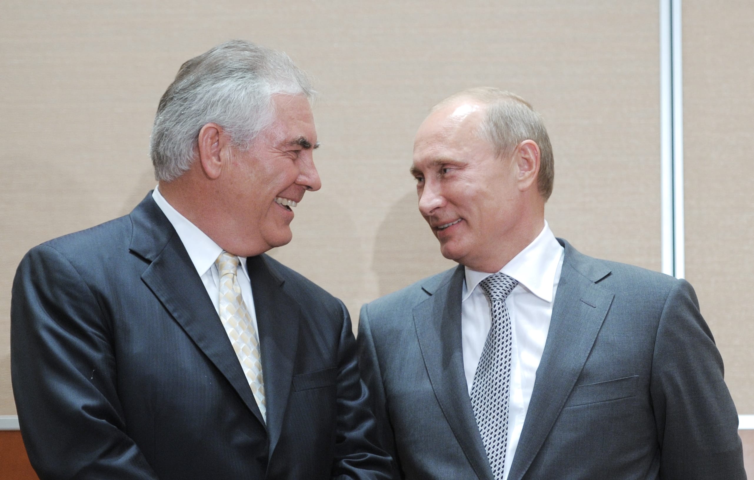 Russia's Prime Minister Vladimir Putin (R) speaks with ExxonMobil President and CEO Rex Tillerson in August 2011. President-elect Donald Trump tapped Mr Tillerson, an oilman with deep ties to Russia, as his secretary of state.