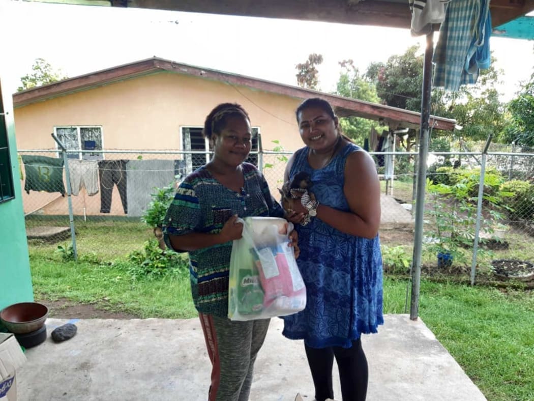 Sheenal Chand, (right), traded a bag of groceries for a new puppy