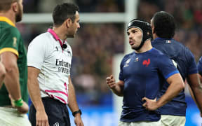 France's captain Antoine Dupont speaks with New Zealand referee Ben O’Keeffe during the France 2023 Rugby World Cup quarter-final match between France and South Africa