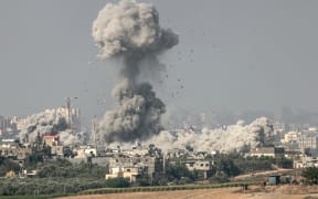 A picture taken from the southern Israeli city of Sderot on 23 October 2023, shows smoke and debris ascending over the northern Gaza Strip following an Israeli strike, amid the ongoing battles between Israel and the Palestinian group Hamas.