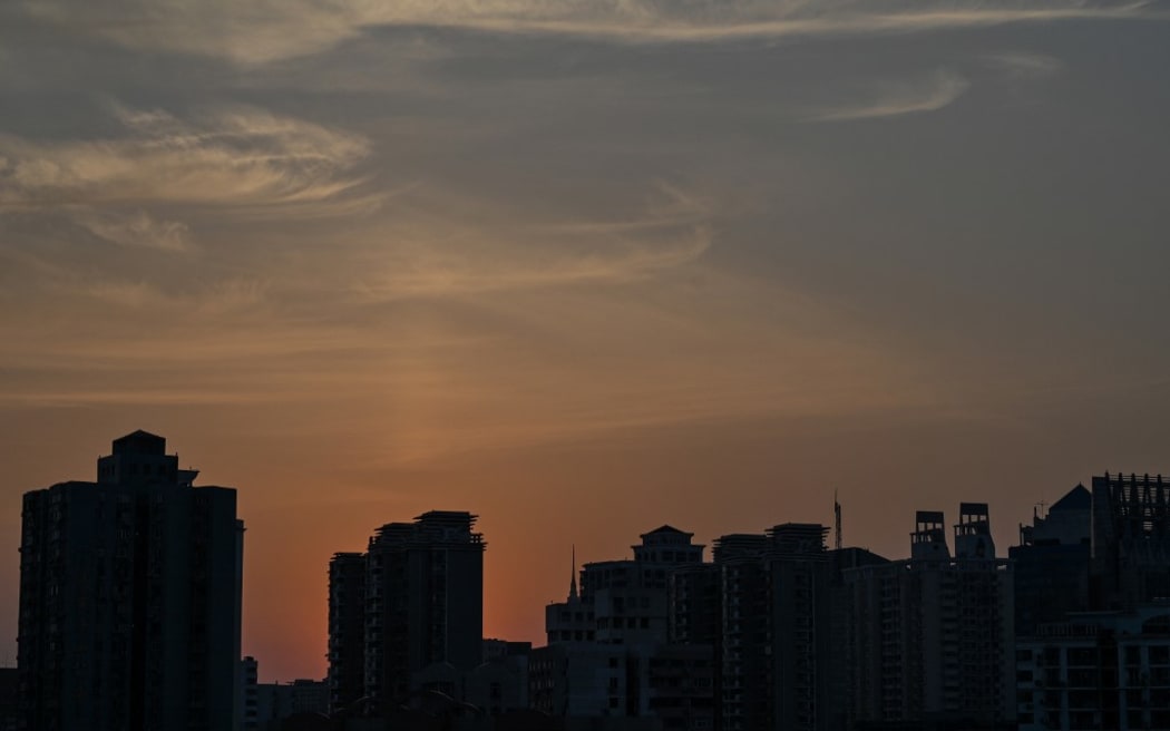 View of residential units during a Covid-19 coronavirus lockdown in the Jing'an district of Shanghai on May 2, 2022. (Photo by Hector RETAMAL / AFP)