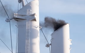 14 September 2019, Hamburg: The heavily smoking chimney of a ship at the Hamburg Cruise Days. In the course of the evening a parade with cruise ships and fireworks was held.