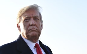 US President Donald Trump speaks with reporters.