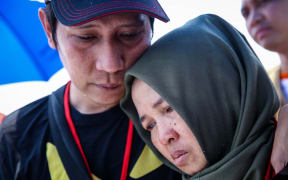Families and colleagues of passengers and crew of Lion Air flight JT610 pray and cry on the deck of Indonesia Navy ship KRI Banda Aceh as they visit the site of the crash to pay their tribute, at the north coast of Karawang, Indonesia, on Tuesday, November 6, 2018.