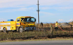 Firefighters fighting a series of fires along the railway line near Kirwee, west of Christchurch.