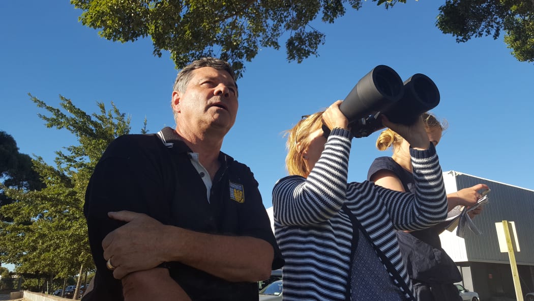 Doug and Vikki Pflaum scan the fire from the flat to see whether or not the flames have reached their house in the Port Hills.