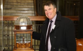 Historian Ian McGibbon with the Versailles Pen in its special wood and leadlighted glass display stand.