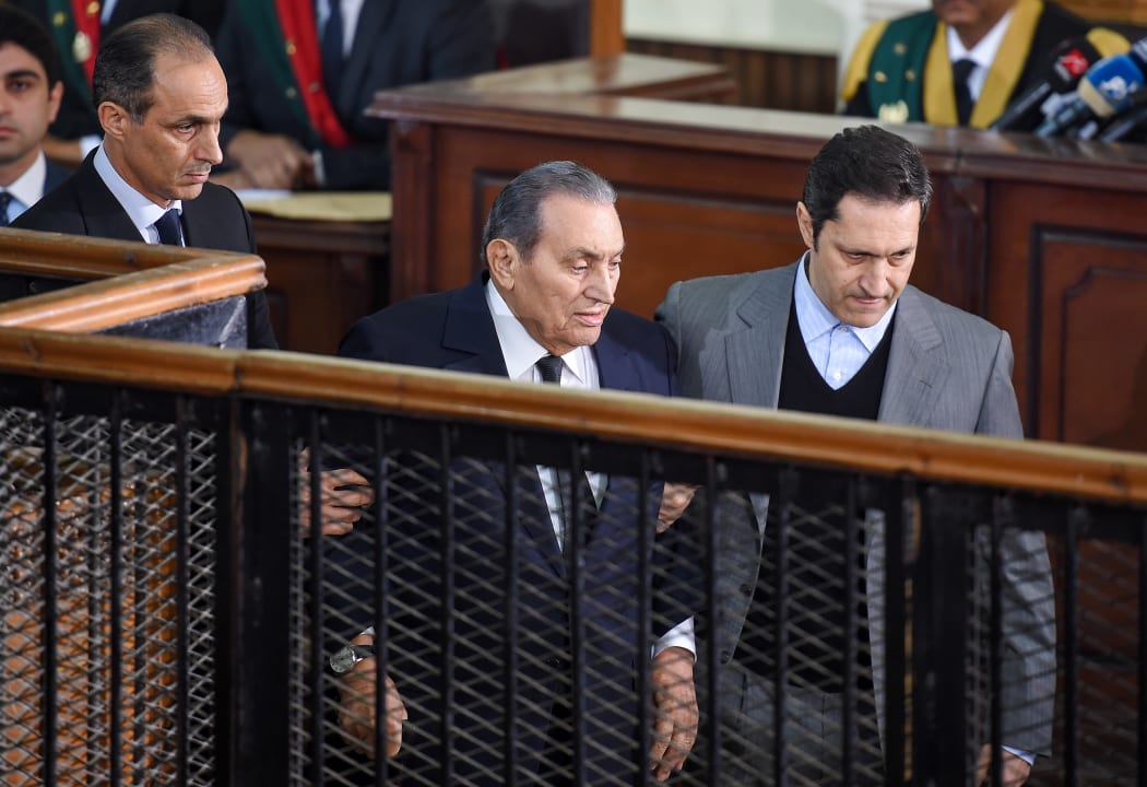 Former Egyptian president Hosni Mubarak, who was ousted following a popular uprising in 2011, being escorted by his two sons Alaa (right) and Gamal (left) as he testifies during a session in the retrial of members of the now-banned Muslim Brotherhood on December 26, 2018.