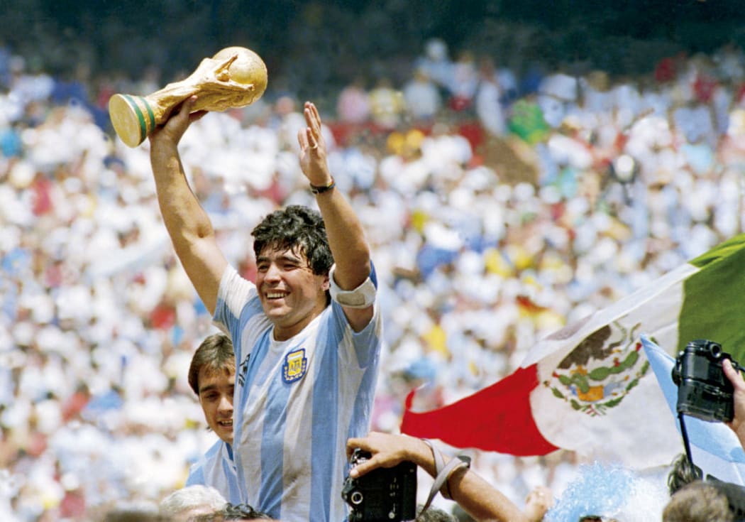 Diego Maradona of Argentina holds the World Cup trophy after defeating West Germany 3-2 during the 1986 FIFA World Cup Final match at the Azteca Stadium on June 29, 1986 in Mexico City, Mexico.