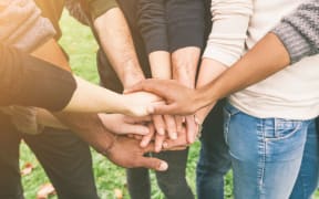 Multiracial Group of Friends with Hands in Stack, Teamwork