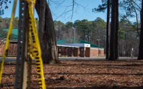 NEWPORT NEWS, VA - JANUARY 07: Police tape hangs from a sign post outside Richneck Elementary School following a shooting on January 7, 2023 in Newport News, Virginia. A 6-year-old student was taken into custody after reportedly shooting a teacher during an altercation in a classroom at Richneck Elementary School on Friday. The teacher, a woman in her 30s, suffered “life-threatening” injuries and remains in critical condition, according to police reports.   Jay Paul/Getty Images/AFP (Photo by Jay Paul / GETTY IMAGES NORTH AMERICA / Getty Images via AFP)