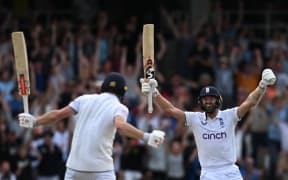 England's Mark Wood, right, celebrates with England's Chris Woakes after Woakes hits a boundary to win the test match on day four of the third Ashes cricket Test match between England and Australia at Headingley cricket ground in Leeds, England on July 9, 2023.