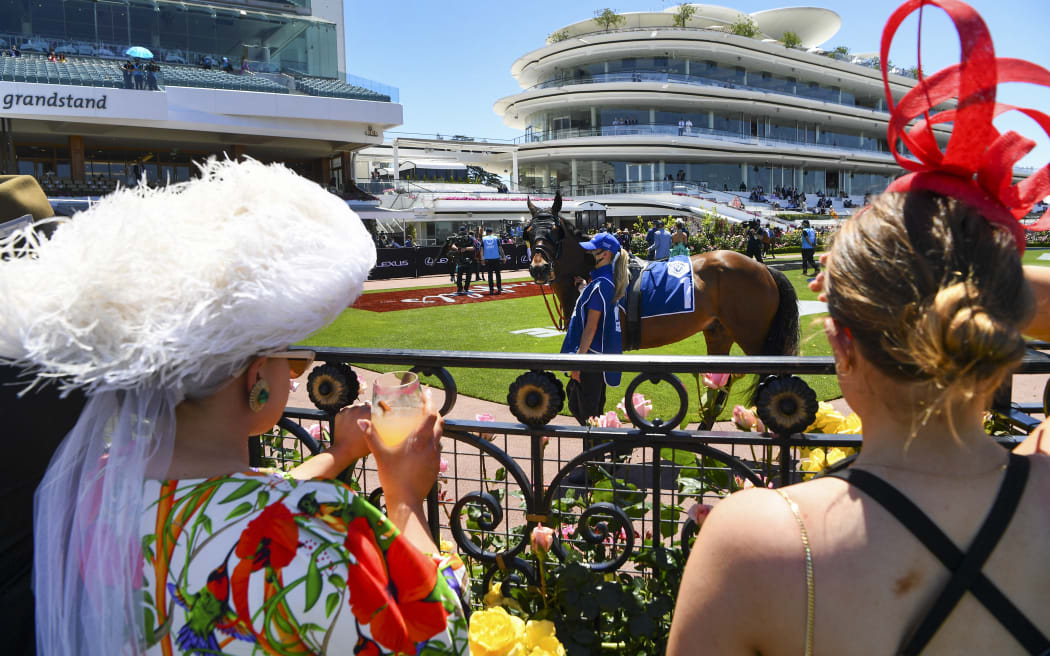People attend the Melbourne Cup horse race as crowds are allowed to return to the Flemington racecourse in Melbourne on November 2, 2021.