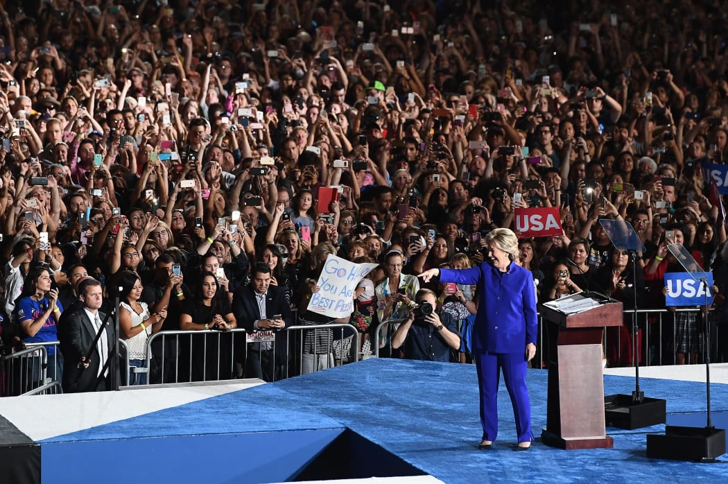 US Democratic presidential nominee Hillary Clinton waves at supporters as she arrives at a campaign rally in Tempe, Arizona, on November 2, 2016.