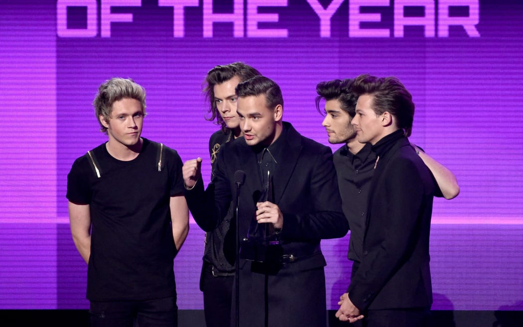 Niall Horan, Harry Styles, Liam Payne, Zayn Malik and Louis Tomlinson of One Direction accept the Artist of the Year award onstage at the American Music Awards on 23 November, 2014 in Los Angeles, California.