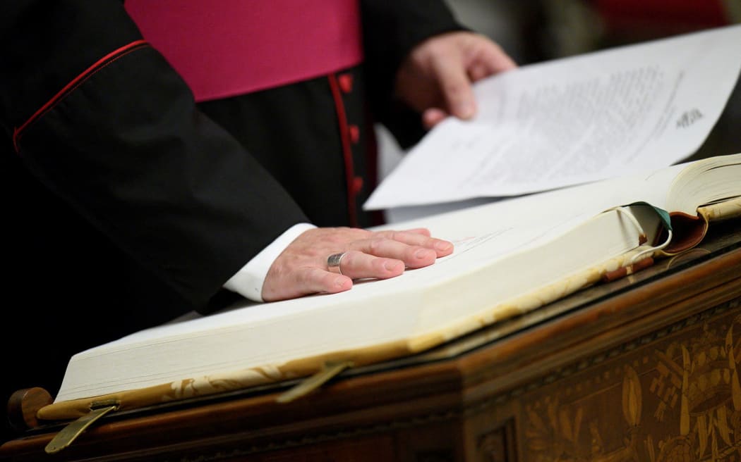 Officials, members of the clergy and conclave staff take an oath of secrecy in the Pauline Chapel, at the Vatican, on Monday.