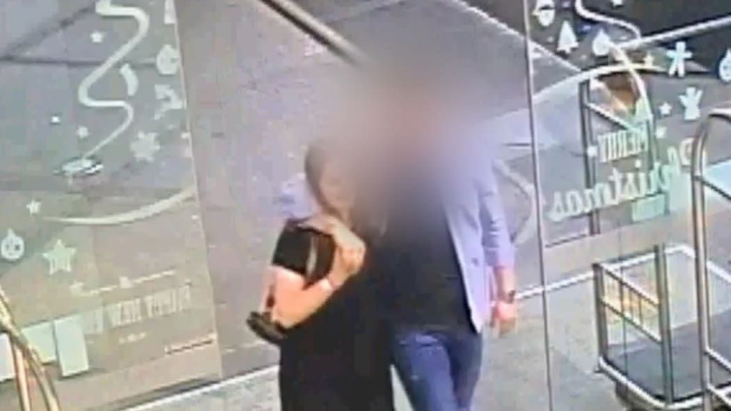 The defendant and Grace Millane hug when meeting for the first time at the base of the Sky Tower in Auckland.