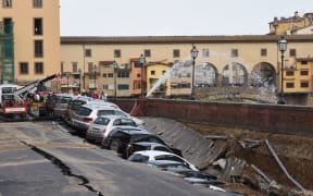The hole swallowed up many parked cars.