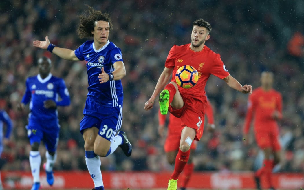 David Luiz of Chelsea battles with Adam Lallana of Liverpool.