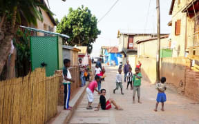 Roso in the street and kids playing