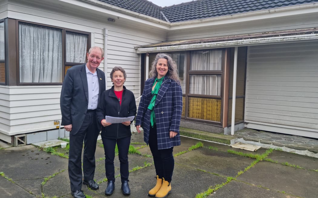Nelson City Councillor Rachel Sanson Nelson Tasman Housing Trust director Carrie Mozena and Nelson mayor Nick Smith outside the Waimea Road property that will be demolished
