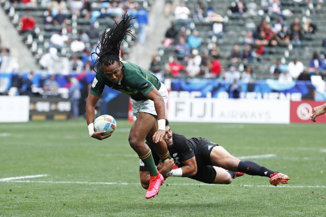 South Africa's Cecil Afrika is caught by New Zealand's Ngarohi McGarvey-Black during their semi-final win