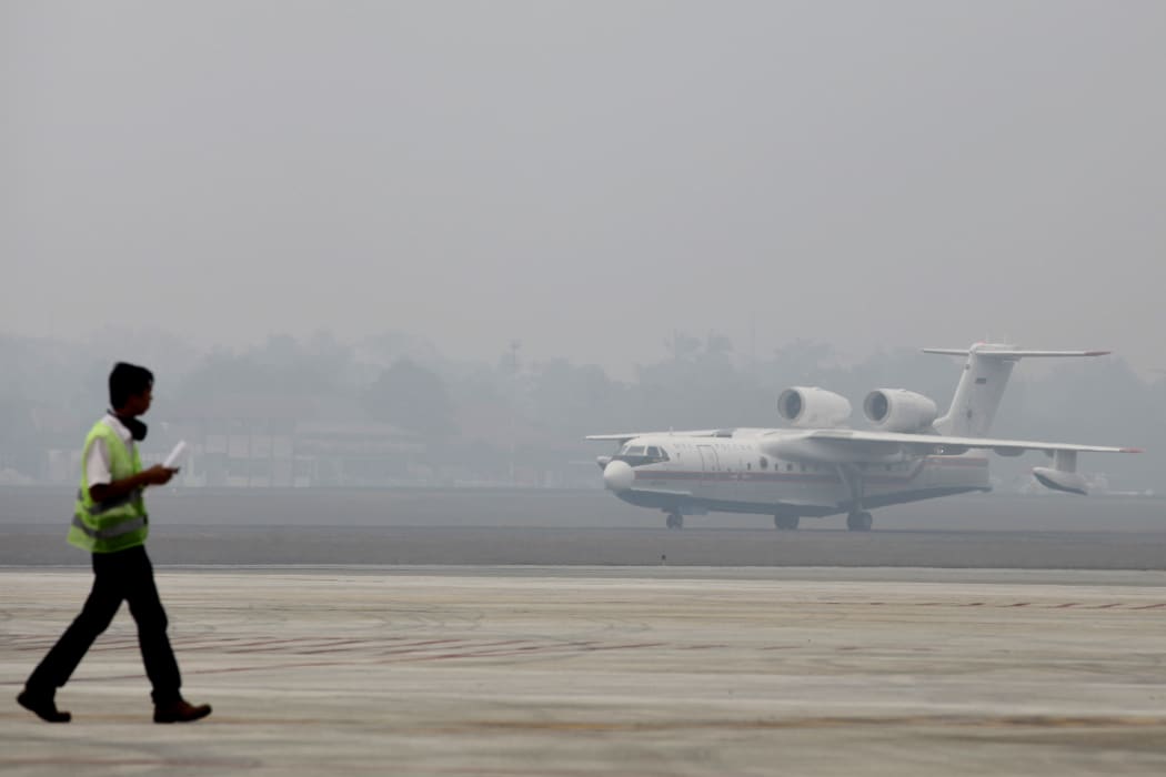 A Russian-made Beriev Be-200 amphibious firefighting aircraft, one of two rented by the Indonesian government to combat its forest and agricultural fires, taxis following its arrival