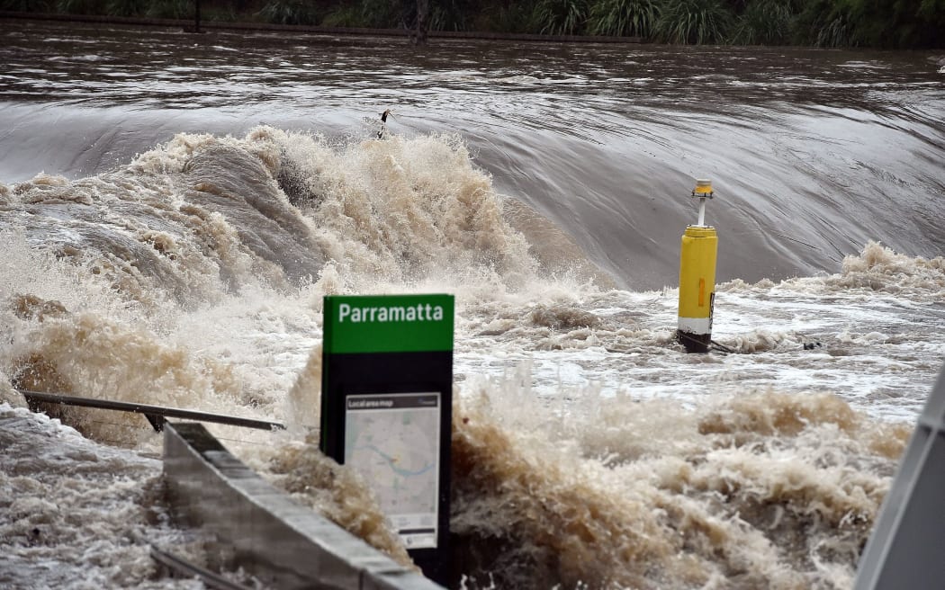 A ferry terminal is submerged by the overflowing Parramatta river in Sydney.