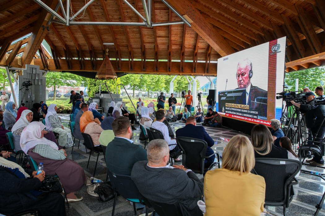Bosnian families follow the final verdict hearing of the former Bosnian Serb general Ratko Mladic in the ethnic cleansing case by the International Criminal Tribunal, from a screen at Srebrenica Genocide Memorial in Potocari in Srebrenica.