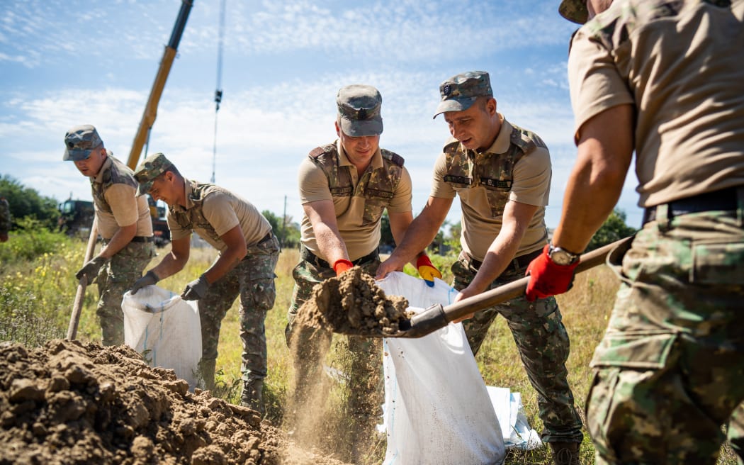 Romanian Army soldiers build a bomb shelter in the village of Plauru, Danube Delta, 300 kilometres east of Bucharest, on 12 September, 2023. Romania's defence ministry announced on 12 September that it had started to set up air-raid shelters for residents in the Plauru area near the Ukraine border after drone fragments were found over the weekend. On 10 September, NATO member Romania said it discovered parts of a drone "similar to those used by the Russian army" and summoned the Russian embassy's charge d'affaires.