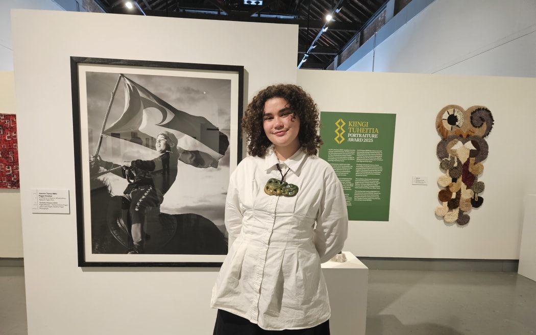 The winner of the 2025 Kiingi Tuheitia Portraiture Award Jazmin Tainui Mihi Paget-Knebel with her winning photo Taniwha Chasers.