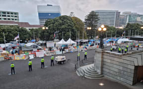 Police undertake an early morning operation to restore order and access to the area around Parliament.