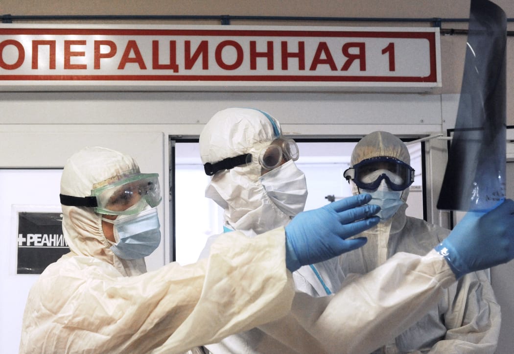 Medics wearing personal protective equipment (PPE) view an X-ray of the lungs at the intensive therapy department of a hospital for people suffering from the coronavirus disease, in Rasskazovo, Tambov region, Russia.