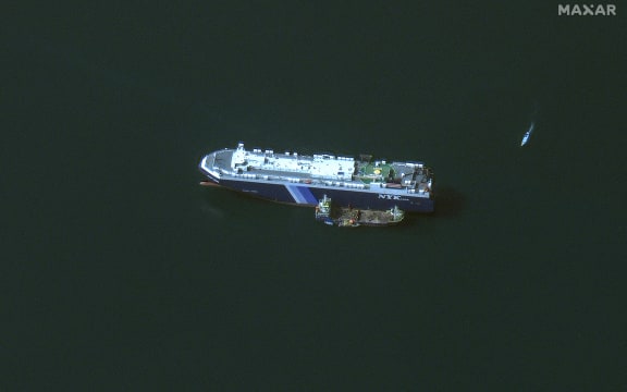 (FILES) This handout satellite picture released by Maxar Technologies on November 28, 2023, shows the recently seized Isreali-linked Galaxy Leader ship, that was captured by Huthi fighters on November 19, next to a support vessel in the southern Red Sea near Hodeida, Yemen. Heavy air strikes pounded rebel-held cities in Yemen early on January 12, 2024, according to the Huthi rebels' official media and AFP correspondents. The capital Sanaa, Hodeida and Saada were all targeted, the Huthis' official media said, blaming "American aggression with British participation". (Photo by Satellite image ©2023 Maxar Technologies / AFP) / RESTRICTED TO EDITORIAL USE - MANDATORY CREDIT "AFP PHOTO / Satellite image ©2023 Maxar Technologies" - NO MARKETING NO ADVERTISING CAMPAIGNS - DISTRIBUTED AS A SERVICE TO CLIENTS - THE WATERMARK MAY NOT BE REMOVED/CROPPED -