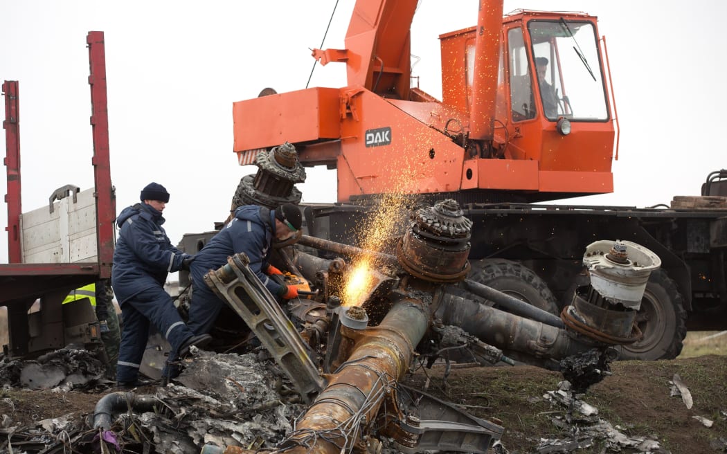 Dutch experts supervise a crew from the self-proclaimed Donetsk People's Republic as they remove parts of Malaysia Airlines Flight MH17 on 16 November in Ukraine.
