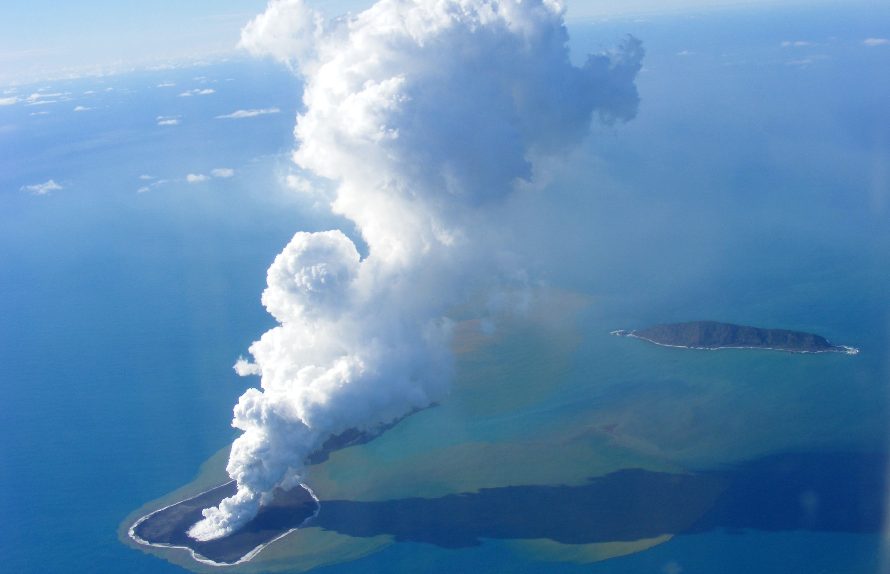 A 2009 aerial photo of ash rising into the air from an undersea volcanic eruption that formed the world's youngest island.