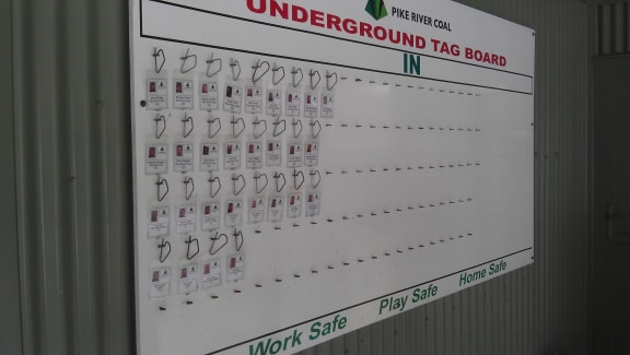 The actual name tags of the 29 Pike mine workers . They remain where the men left them before they  went underground two years ago.