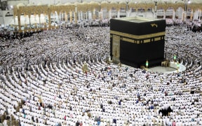 Muslim worshippers pray at the Kaaba, Islam's holiest shrine, at the Grand Mosque in Mecca on 23 June 2017, during the last Friday of the holy month of Ramadan.
