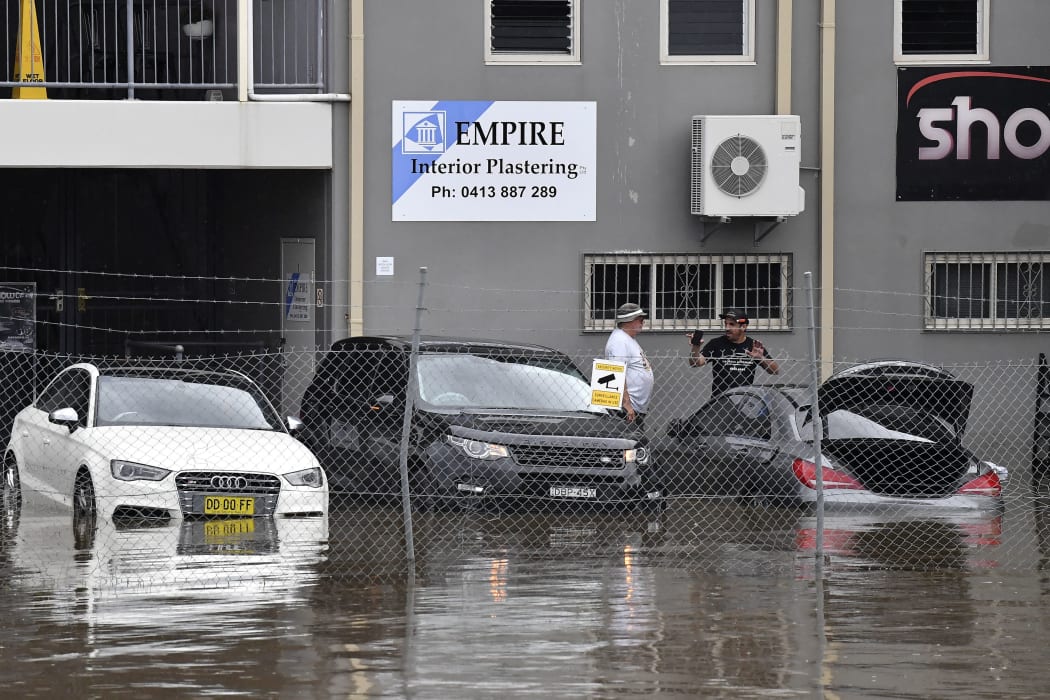 Residents in the southwestern Sydney suburb of Camden check cars stranded in floodwaters on 8 March 2022.
