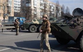 KYIV, UKRAINE - FEBRUARY 25: Ukrainian servicemen stand on patrol at a security checkpoint on February 25, 2022 in Kyiv, Ukraine.